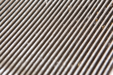 The old cabin air filter is clogged with dust and dirt. close-up photo of the structure