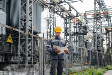 The energy engineer inspects the equipment of the substation. Power engineering. Industry