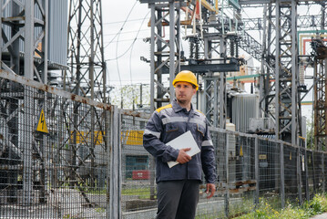 The energy engineer inspects the equipment of the substation. Power engineering. Industry