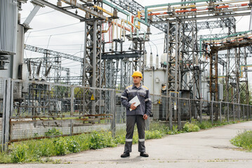 The energy engineer inspects the equipment of the substation. Power engineering. Industry