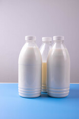 coconut lactose free milk in plastic bottles on blue surface
