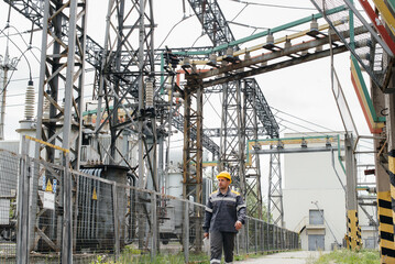 An engineering employee makes a tour and inspection of a modern electrical substation. Energy. Industry