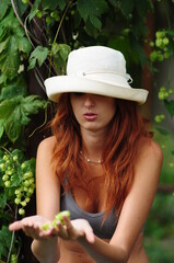 Elegant smoking woman. Portrait of a red-haired girl with a cigar