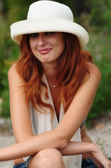 Elegant smoking woman. Portrait of a red-haired girl with a cigar