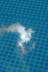 reflection of the sun and clouds in the water