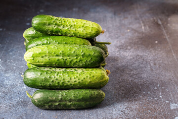 Heap of fresh cucumbers on grunge background with copy space