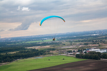 paraglider in the sky/ paramoto pilot flying in the sky