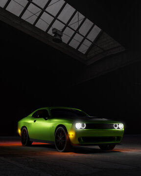 Green Dodge Challenger Hellcat car in a warehouse