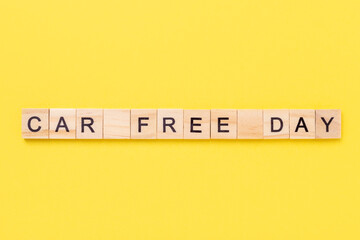Text Car Free Day on yellow background. Concept of world car free day on September 22. Top view