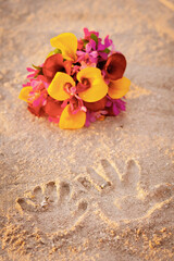 Wedding bouquet with handprints in the sand