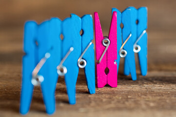 colorful wooden clothespin - abstract vision of man and woman. standing out from the crowd,...