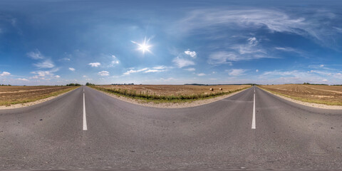 Full spherical seamless panorama 360 degrees angle view on no traffic old asphalt road among fields...