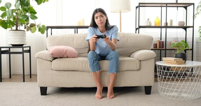 Woman displeased on losing a video game match at home