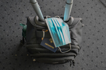 Traveling during covid19 epidemic. Passport and protective face mask respirator in airport. Coronavirus new travel concept.