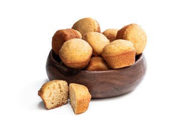 Small vanilla cakes in wooden bowl isolated on white background