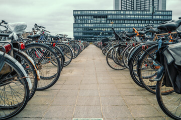 Fototapeta na wymiar Many bicycles parked bike parking area in Amsterdam, The Netherlands.