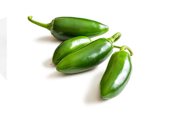 Jalapeno peppers with a shiny green skin on a white background