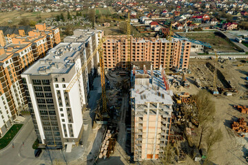 Construction and construction of high-rise buildings, the construction industry with working equipment and workers. View from above, from above. Background and texture