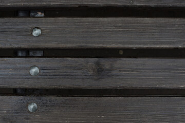 brown bench boards with nails or bolts, background