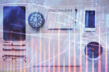 Double exposure of forex graph hologram over desktop with phone. Top view. Mobile trade platform concept.