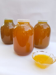 Honey in large glass jars on a white background