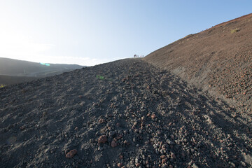 Walking over the top of the Crateri Silvestri, ground grated by the lava stones of the Etna eruption of 1892, Sicily, South of Italy.