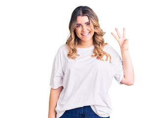 Fototapeta na wymiar Young caucasian woman wearing casual clothes showing and pointing up with fingers number three while smiling confident and happy.