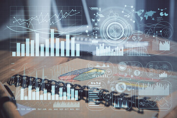 Double exposure of financial graph drawings and desk with open notebook background. Concept of forex market