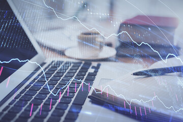 Double exposure of financial chart drawing and desktop with coffee and items on table background. Concept of forex market trading