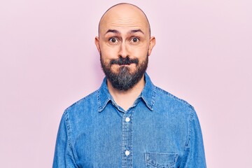 Young handsome man wearing casual clothes puffing cheeks with funny face. mouth inflated with air, crazy expression.