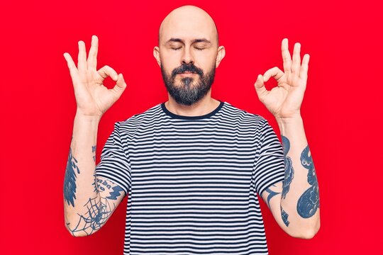 Young handsome man wearing casual clothes relax and smiling with eyes closed doing meditation gesture with fingers. yoga concept.