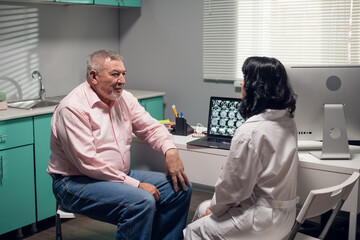 A professional doctor showing the results of the diagnosis to her patient.