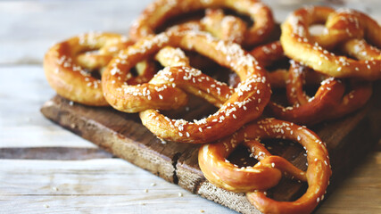 Fresh homemade pretzels on a wooden surface. Oktoberfest symbol.