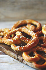 Fresh homemade pretzels on a wooden surface. Oktoberfest symbol.