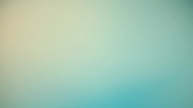 Blue defocused glow motion abstract background. Cyan beige color gradient blur soft illumination flow. Bokeh light lens flare texture effect overlay. Ocean water surface reflection.