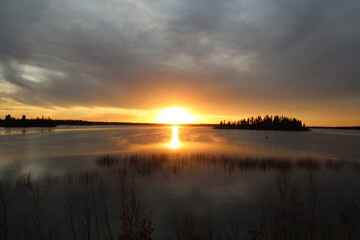 Fototapeta na wymiar Rays Of Sunset On The Water, Elk Island National Park, Alberta