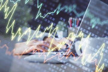 Double exposure of woman hands typing on computer and forex chart hologram drawing. Stock market invest concept.