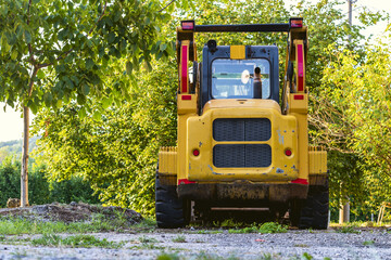 rear view of industrial vehicle earth mover parked in a field,low angle view