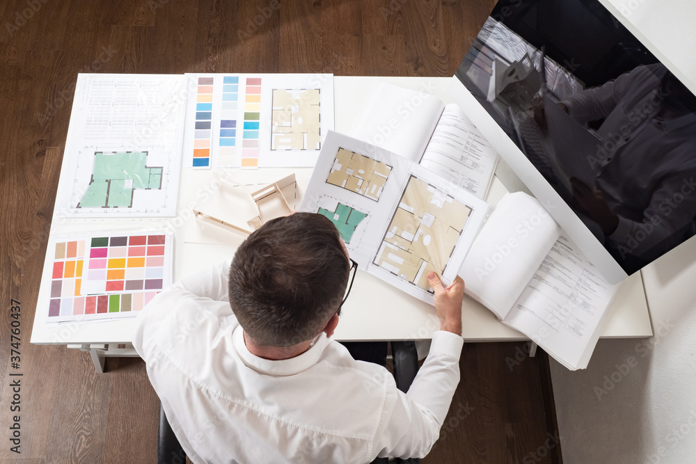 Poster architect at work. a man with construction documentation, building layout and color palette. the int