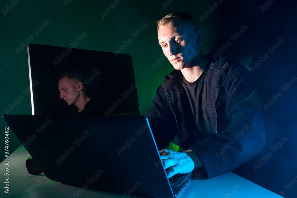 Poster a man performs urgent work on a laptop. human and computer gadgets. irregular working hours. working