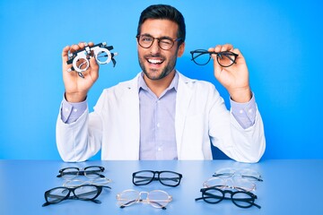 Young hispanic man with optometry glasses winking looking at the camera with sexy expression,...