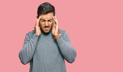 Handsome hispanic man wearing casual clothes with hand on head for pain in head because stress. suffering migraine.