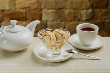 White ice cream in a glass glass with caramel.