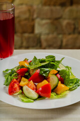 Summer fresh salad of tomato cucumber leaves lettuce.