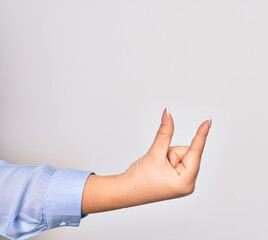 Hand of caucasian young woman doing catch sign over isolated white background