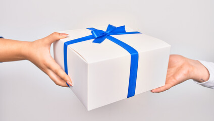 Hand of caucasian young woman giving birthday gift to other person over isolated white background
