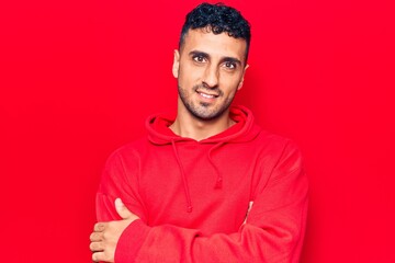 Obraz premium Young hispanic man wearing casual clothes happy face smiling with crossed arms looking at the camera. positive person.