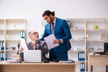 Two male colleagues working in the office