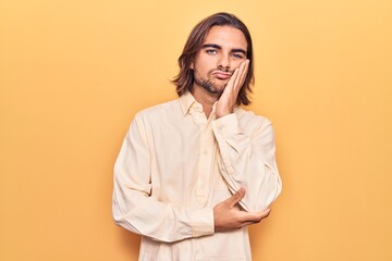 Young handsome man wearing business clothes thinking looking tired and bored with depression problems with crossed arms.