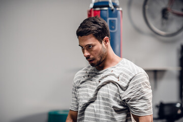 Boxing coach a young male boxer sets up for training in the gym